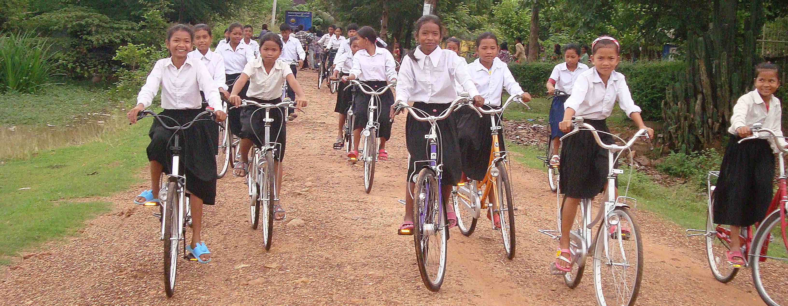 Cambodia - Children riding to school on bikes.